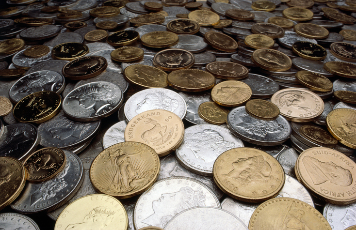 Collection of gold and silver coins on a table